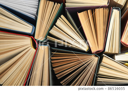 Many different hardcover books on dark background, top view 86516035