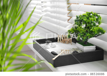 Beautiful miniature zen garden on window sill Beautiful miniature zen garden on window sill 86516086
