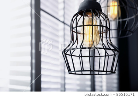 Stylish metallic pendant lamp with Edison light bulb indoors Stylish metallic pendant lamp with Edison light bulb indoors 86516171