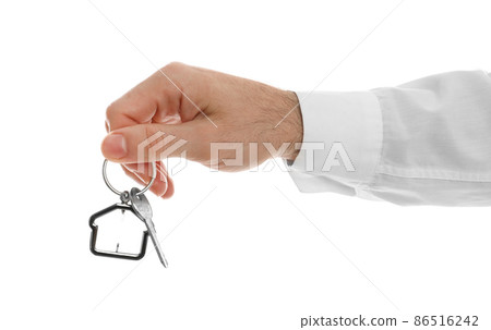 Real estate agent holding house key with trinket on white background, closeup Real estate agent holding house key with trinket on white background, closeup 86516242