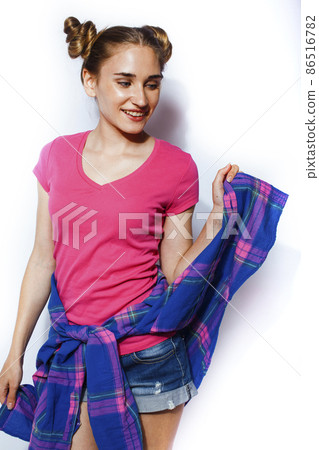 young pretty teenage hipster girl posing emotional happy smiling on white background, lifestyle people concept 86516782