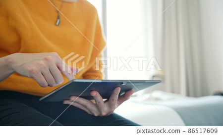 A woman using a tablet A woman using a tablet 86517609