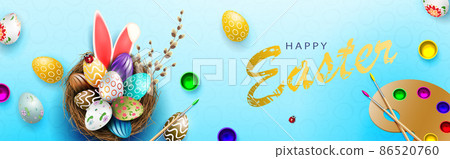 Blue composition with Easter eggs in the nest, rabbit ears, palette with paints 86520760