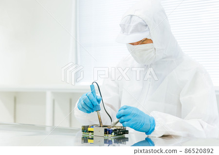 Men soldering in a clean room Men soldering in a clean room 86520892