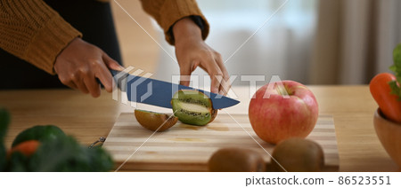 Cropped shot healthy young woman preparing ingredients for making vegan food in kitchen. Cropped shot healthy young woman preparing ingredients for making vegan food in kitchen. 86523551