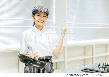 Woman cooking with frying pan Woman cooking with frying pan 86523762
