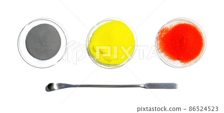 Zinc Powder, Potassium Chromate and Potassium Dichromate in chemical watch glass placed next to the stainless spatula. Closeup chemical ingredient on white laboratory table. Top View 86524523