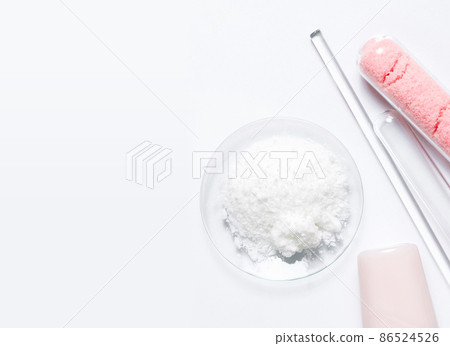 Beauty care cream, himalayan pink salt and Polyacrylic acid powder placed next to Stirring Rod and Test tube. Chemicals for beauty care on white laboratory table. (Top View) 86524526