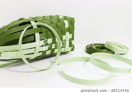 Paper band handmade image in the middle of production (white background, copy space) Paper band handmade image in the middle of production (white background, copy space) 86524540