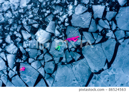 Rescue team on frozen blocks of ice. Kid and woman alone on frozen water on winter river. Lie on the cracked ice of frozen river. Waiting for help in iced water. Rescuing kid and woman from water Rescue team on frozen blocks of ice. Kid and woman alone on frozen water on winter river. Lie on the cracked ice of frozen river. Waiting for help in iced water. Rescuing kid and woman from water 86524563
