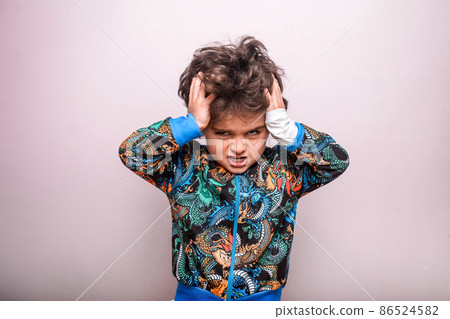 Amazed angry kid with hands on head isolated on white background. Kid in with big head holding hair on head. Bad news and a lot of homework task to do at school. Back to school 86524582