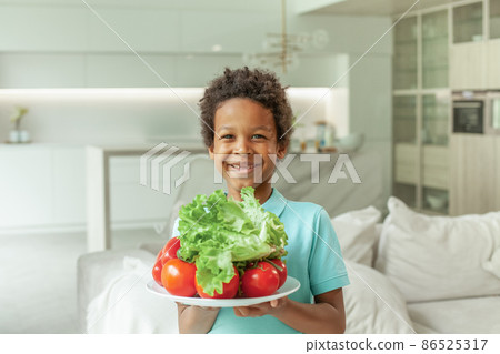 Happy healthy child boy with fresh vegetables portrait 86525317