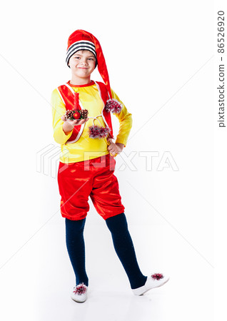 A baby dressed as a elf. isolated. Santa's helper. boy in suit of dwarf or elf A baby dressed as a elf. isolated. Santa's helper. boy in suit of dwarf or elf 86526920