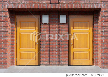 Modern entrance to the house, twin wooden doors. Modern entrance to the house, twin wooden doors. 86529399