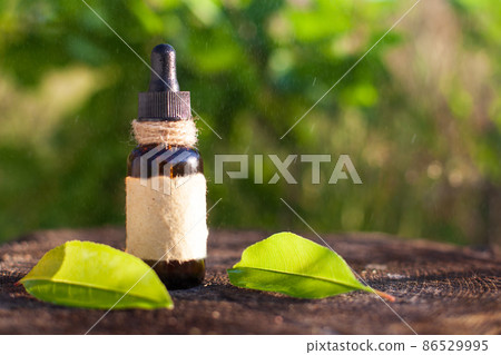 Natural herbal oil in a bottle with a blank label. 86529995