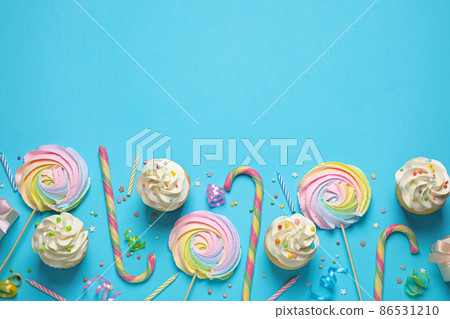 Flat lay composition with cupcakes on light blue background, space for text. Birthday party Flat lay composition with cupcakes on light blue background, space for text. Birthday party 86531210