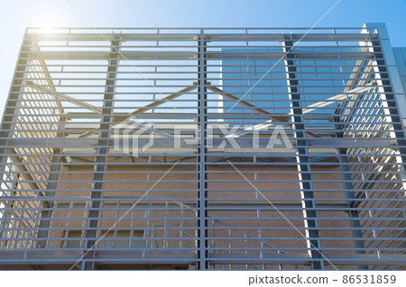 The exterior interior of the building in the form of a metal contruction against a blue sky background The exterior interior of the building in the form of a metal contruction against a blue sky background 86531859