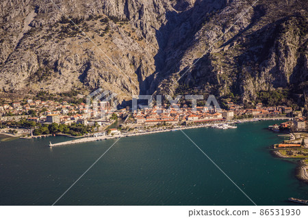 Old city. Kotor. Montenegro. Narrow streets and old houses of Kotor at sunset. View of Kotor from the city wall. View from above Old city. Kotor. Montenegro. Narrow streets and old houses of Kotor at sunset. View of Kotor from the city wall. View from above 86531930