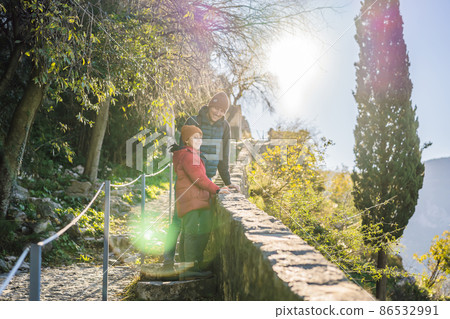 Dad and son travelers in Montenegro in Kotor Old Town Ladder of Kotor Fortress Hiking Trail. Aerial drone view 86532991
