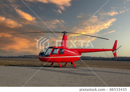 Little red helicopter at take-off site. ROBINSON 86533435