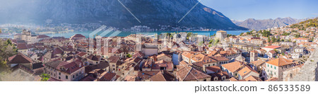 Old city. Kotor. Montenegro. Narrow streets and old houses of Kotor at sunset. View of Kotor from the city wall. View from above Old city. Kotor. Montenegro. Narrow streets and old houses of Kotor at sunset. View of Kotor from the city wall. View from above 86533589