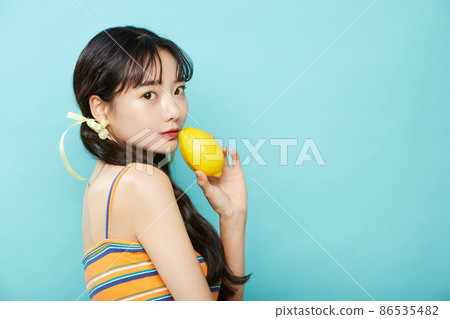 Fresh portrait of young woman on blue background Fresh portrait of young woman on blue background 86535482