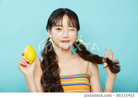 Fresh portrait of young woman on blue background Fresh portrait of young woman on blue background 86535483