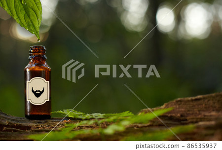 Essential oil for beard or aromatherapy in glass bottl. Copy space on bottle 86535937
