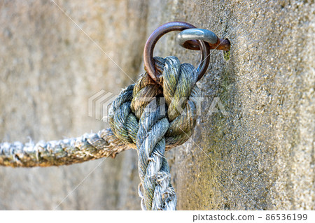 A holder in the rock with a rope as a railing A holder in the rock with a rope as a railing 86536199