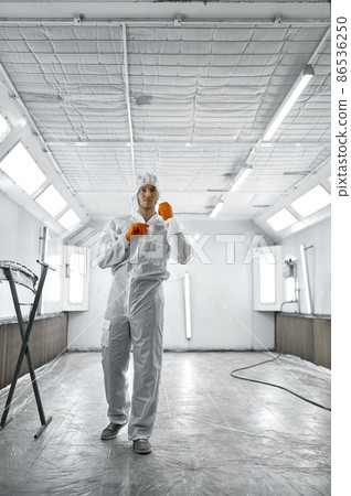 Portrait automobile painter standing in paint chamber 86536250