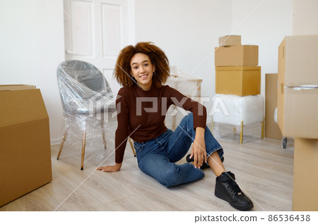 Woman sitting among carton boxes with beginnings Woman sitting among carton boxes with beginnings 86536438