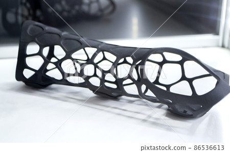 Black orthopedic plastic prosthesis printed on powder 3D printer for hand. Black orthopedic plastic prosthesis printed on powder 3D printer for hand. 86536613