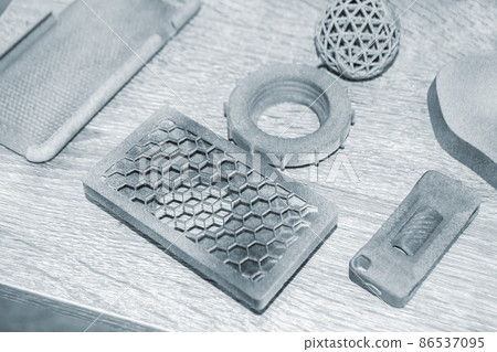 Different gray models printed on 3d printer from powder close-up. 3D prototype 86537095