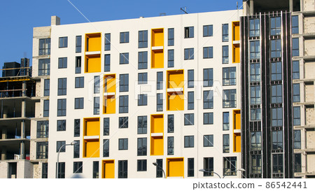Facade of a new multi-story residential building. architecture and modern construction Facade of a new multi-story residential building. architecture and modern construction 86542441