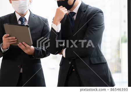 A businessman who works while wearing a mask without a face A businessman who works while wearing a mask without a face 86546393