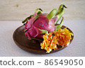 Dragon fruit and flowers on a wooden plate 86549050