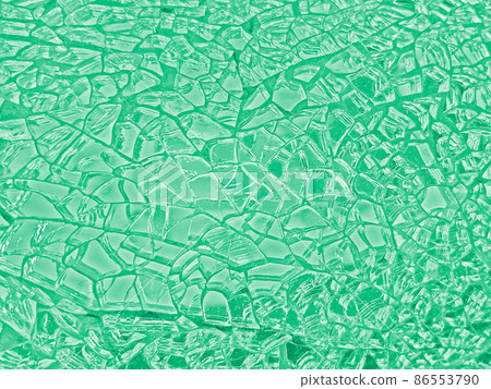 Background image of a finely cracked glass mirror that glows in emerald green Background image of a finely cracked glass mirror that glows in emerald green 86553790