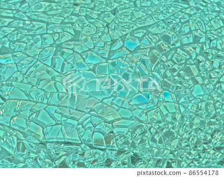 Background image of a finely cracked glass mirror that glows in turquoise and pale green Background image of a finely cracked glass mirror that glows in turquoise and pale green 86554178