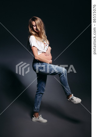 Stylish pregnant woman wearing in jeans holding 86555076