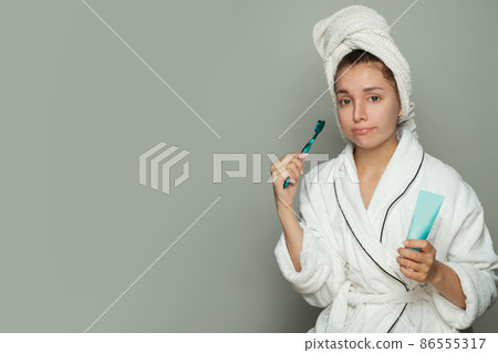 Early morning. Sleepy woman brushing her teeth. Morning routine 86555317