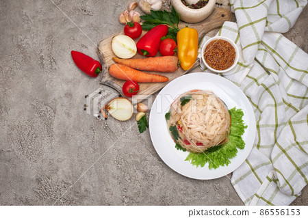 Delicious chicken aspic on a plate on concrete table Delicious chicken aspic on a plate on concrete table 86556153
