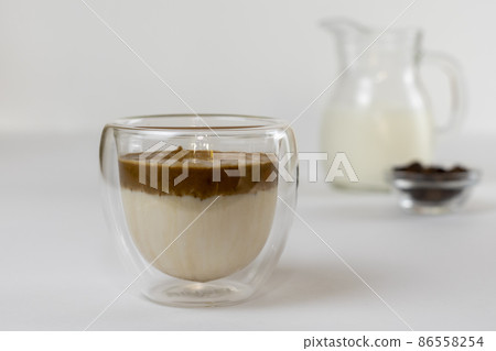 Cold dalgona coffee. Whipped instant coffee. Popular coffee. Latte espresso with coffee foam in a glass. Cold dalgona coffee. Whipped instant coffee. Popular coffee. Latte espresso with coffee foam in a glass. 86558254