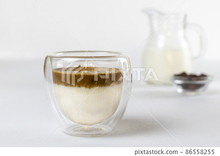 Cold dalgona coffee. Whipped instant coffee. Popular coffee. Latte espresso with coffee foam in a glass. Cold dalgona coffee. Whipped instant coffee. Popular coffee. Latte espresso with coffee foam in a glass. 86558255
