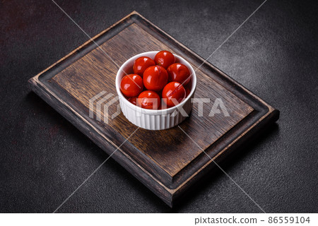 Delicious red canned cherry tomatoes in white piala Delicious red canned cherry tomatoes in white piala 86559104