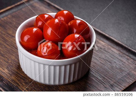 Delicious red canned cherry tomatoes in white piala Delicious red canned cherry tomatoes in white piala 86559106