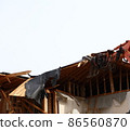 Demolition work site demolition vacant lot real estate housing rebuilding demolition work site heavy machinery construction work chipping 86560870