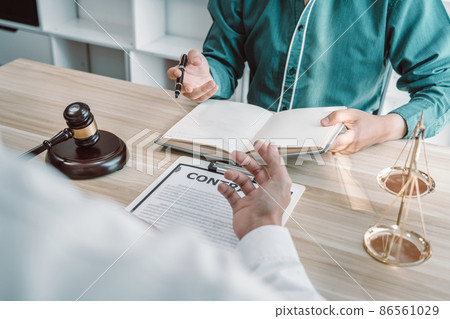 Male lawyer is meeting with businessman client to discuss consultation with litigation contract papers document of estate working in a workplace 86561029