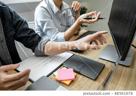Programmer Team of  Developing programming and website working in a software develop company office, writing codes and typing data code, Programming with HTML, PHP and javascript 86561078