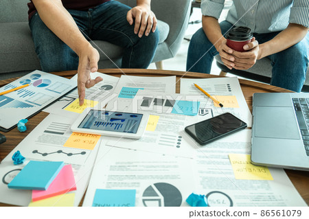 Business casual team are presenting and discussing company growth project success financial statistics, professional investor working start up project for strategy plan with document 86561079