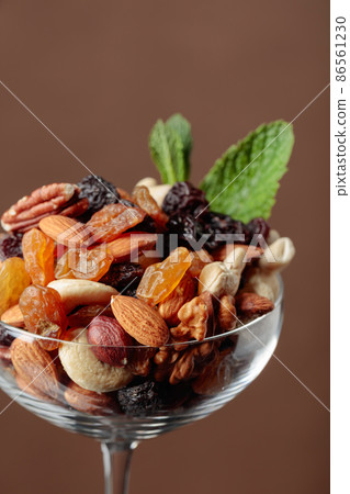 Nuts and raisins garnished with mint. Nuts and raisins garnished with mint. 86561230